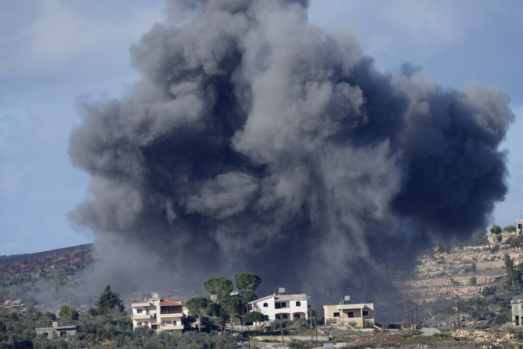 Black smoke rises from an Israeli airstrike on the outskirts of Aita al-Shaab, a Lebanese border village with Israel as it is seen from Rmeish village in south Lebanon, Nov. 21, 2023. (AP Photo/Hussein Malla, File)